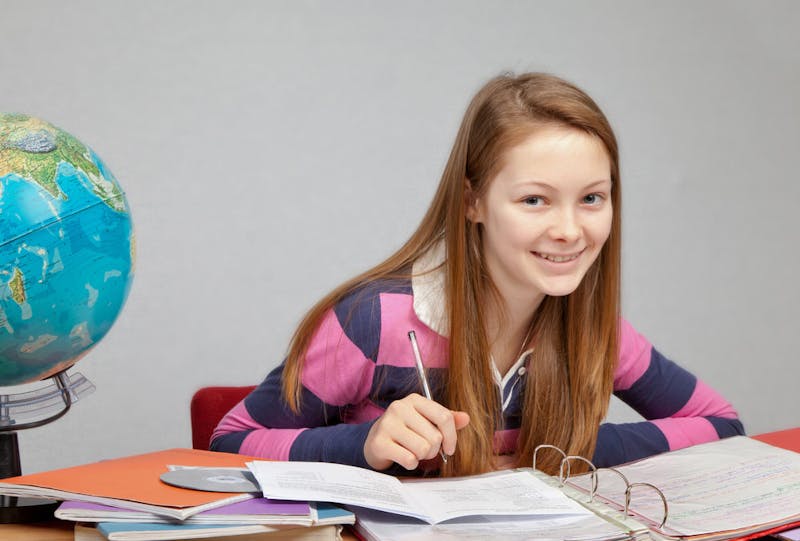 Smiling girl with globe